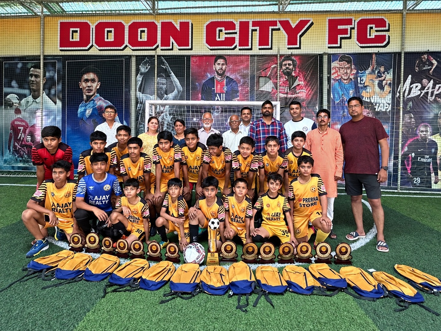 Doon City FC junior team celebrating together at the indoor turf